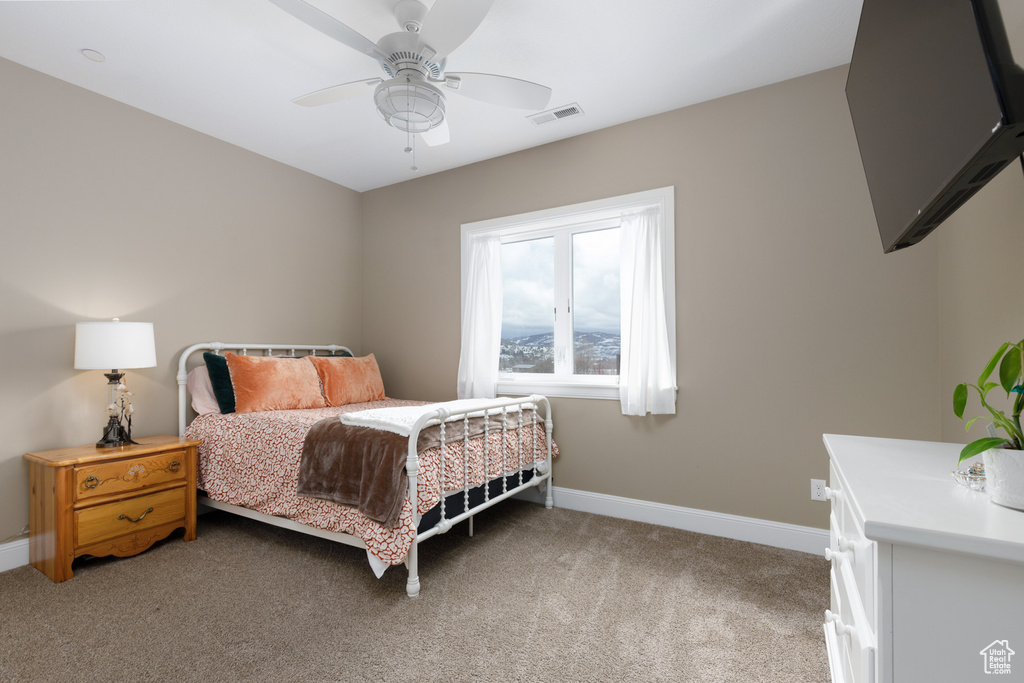 Bedroom with light carpet and ceiling fan