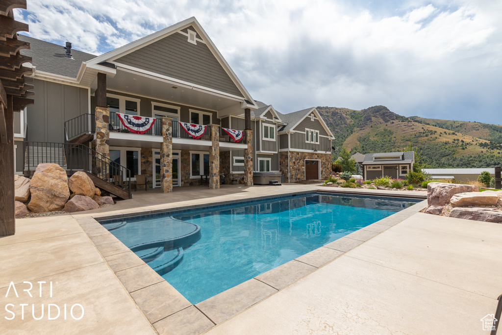 View of swimming pool featuring a mountain view and a patio area
