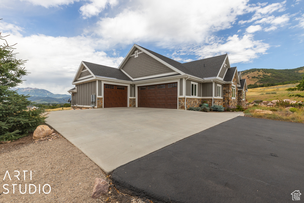 Craftsman inspired home with a mountain view and a garage