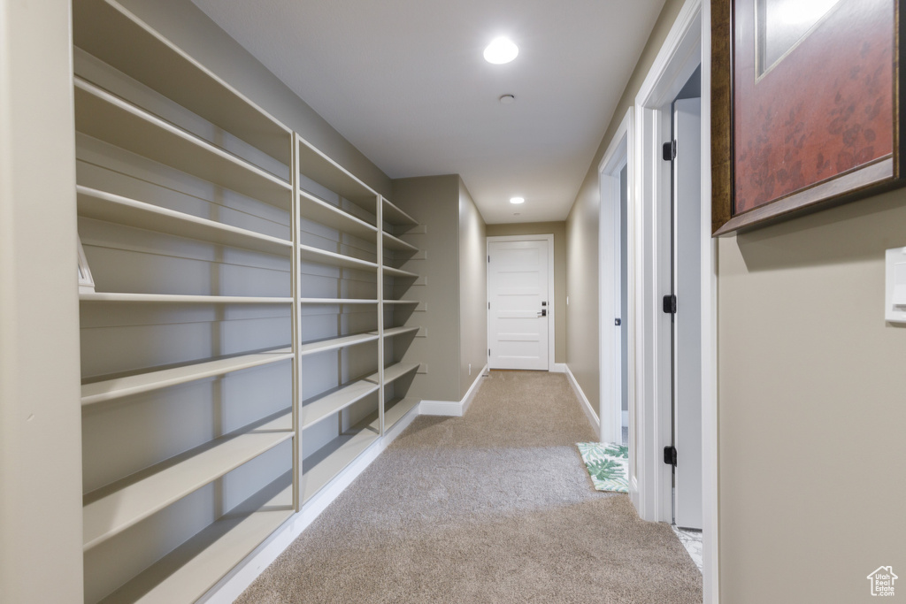 Hall featuring light colored carpet