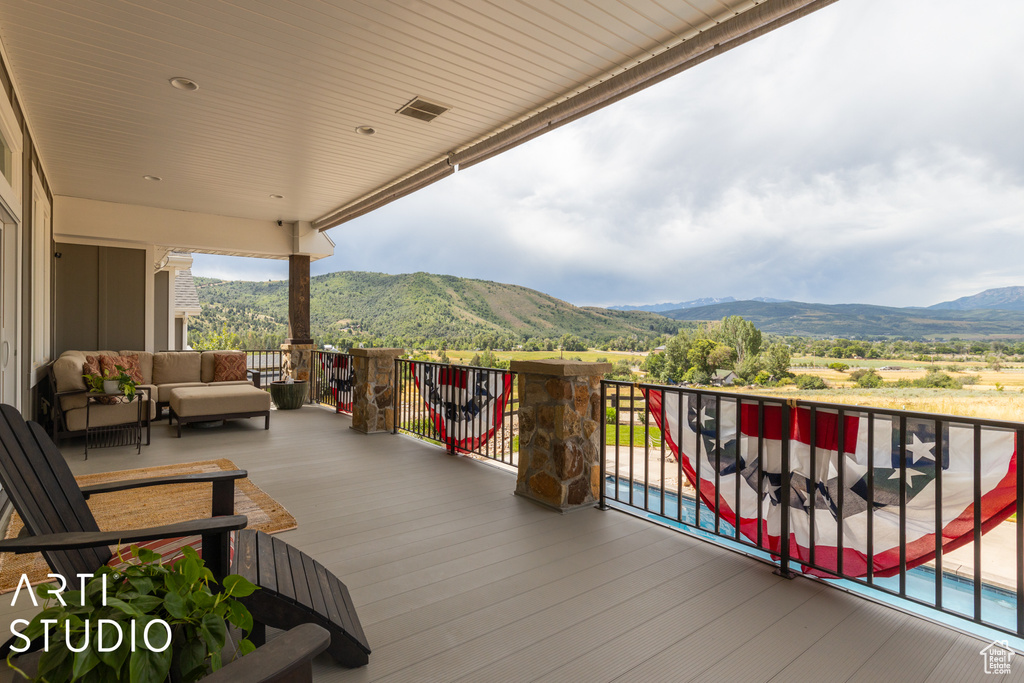 Wooden terrace with a mountain view and outdoor lounge area