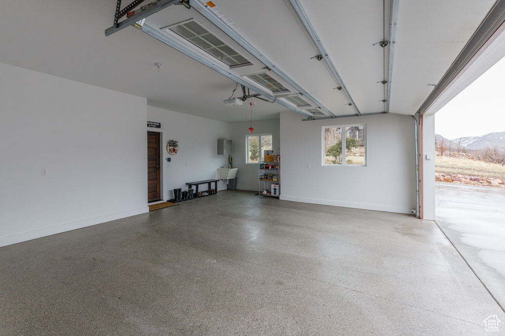 Garage with a garage door opener and a mountain view