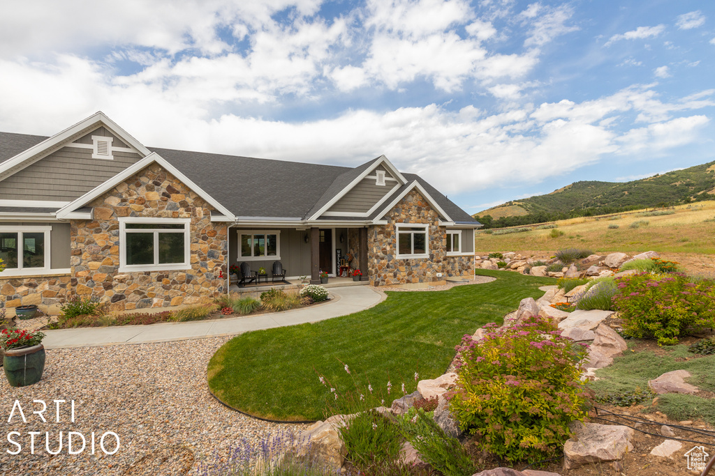 Craftsman house featuring a mountain view and a front lawn