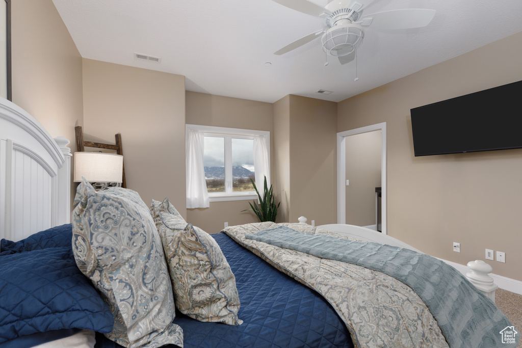 Bedroom featuring ceiling fan and carpet flooring