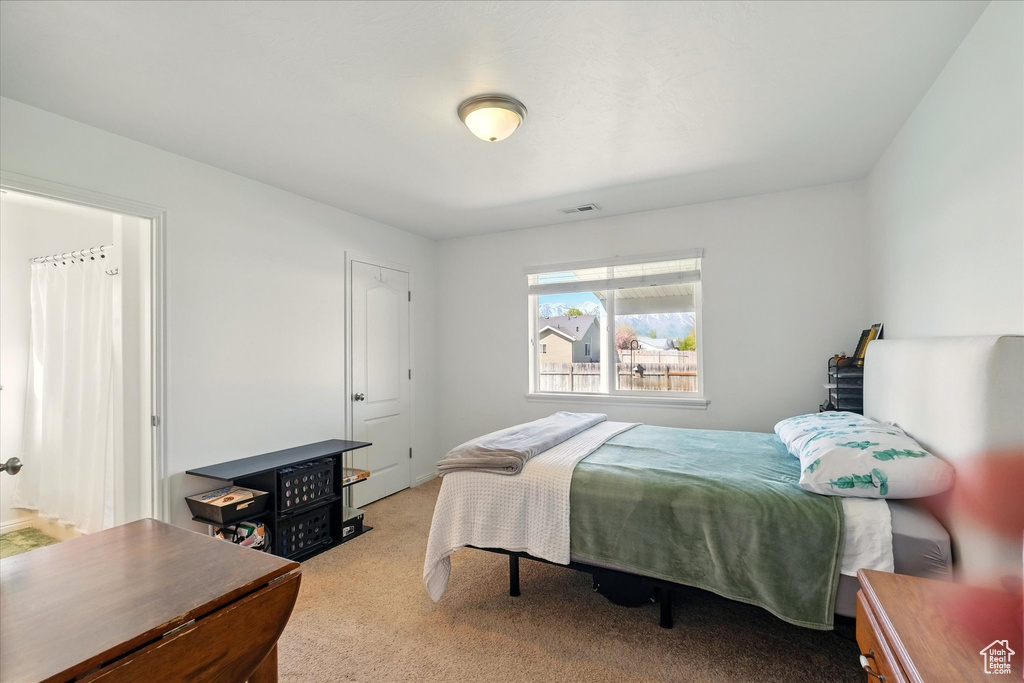 Carpeted bedroom featuring visible vents
