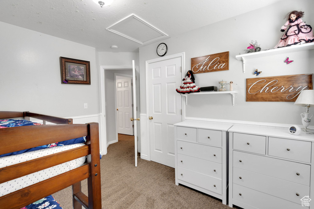 Bedroom with light carpet and attic access