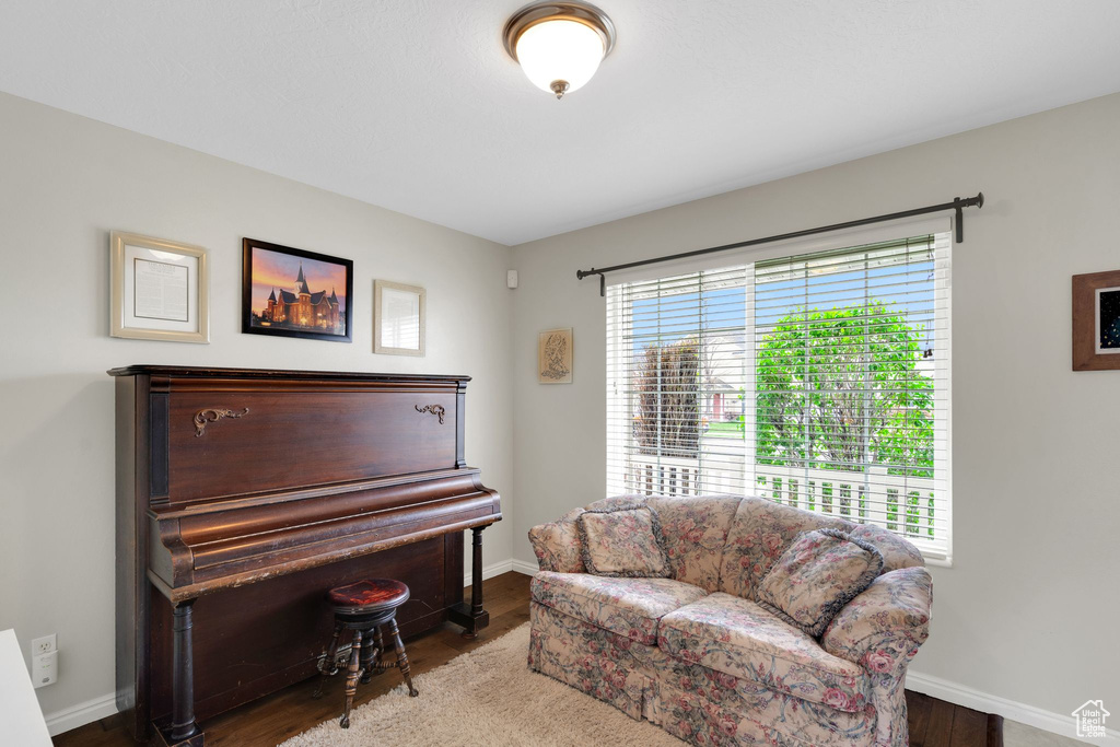 Living area featuring baseboards and wood finished floors