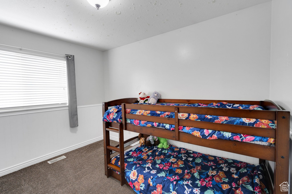 Bedroom with visible vents, carpet, and baseboards