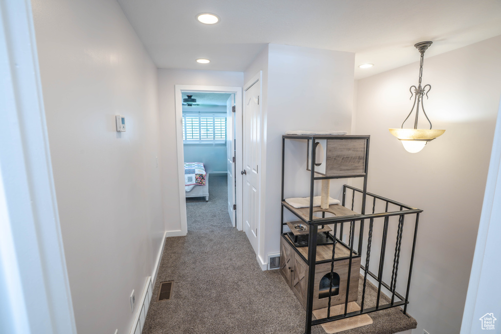 Corridor featuring carpet floors, recessed lighting, baseboards, and an upstairs landing