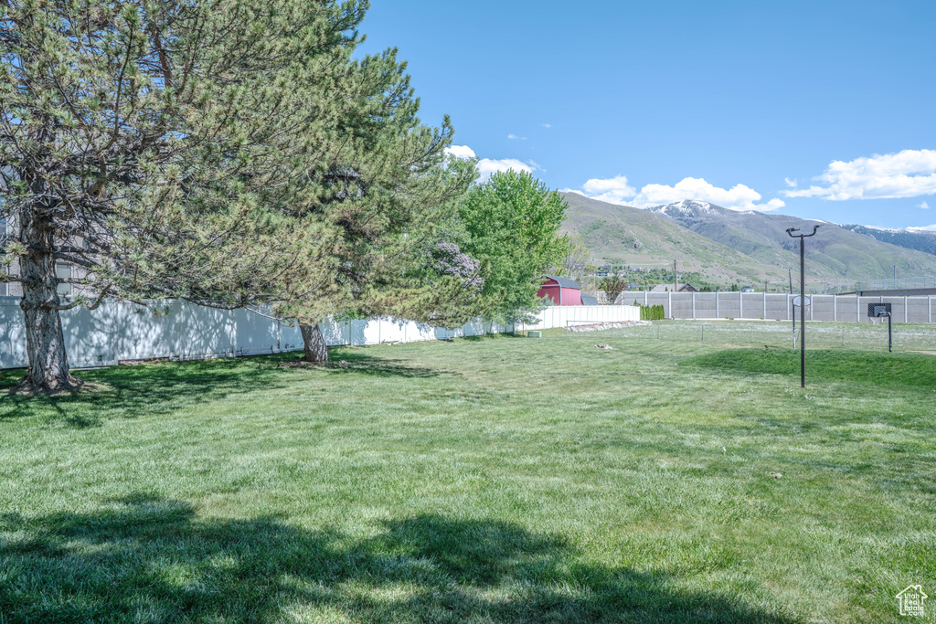 View of yard featuring a fenced backyard and a mountain view