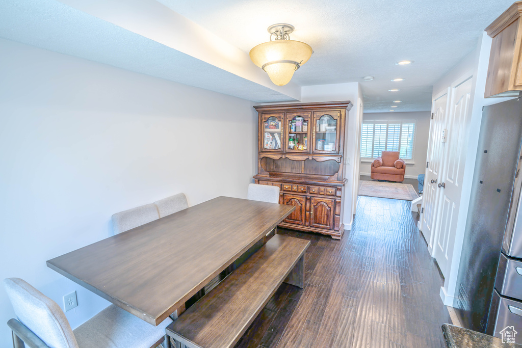 Dining room featuring baseboards, recessed lighting, and dark wood-type flooring