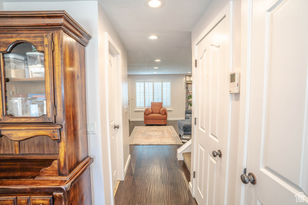 Corridor with baseboards, recessed lighting, and wood finished floors