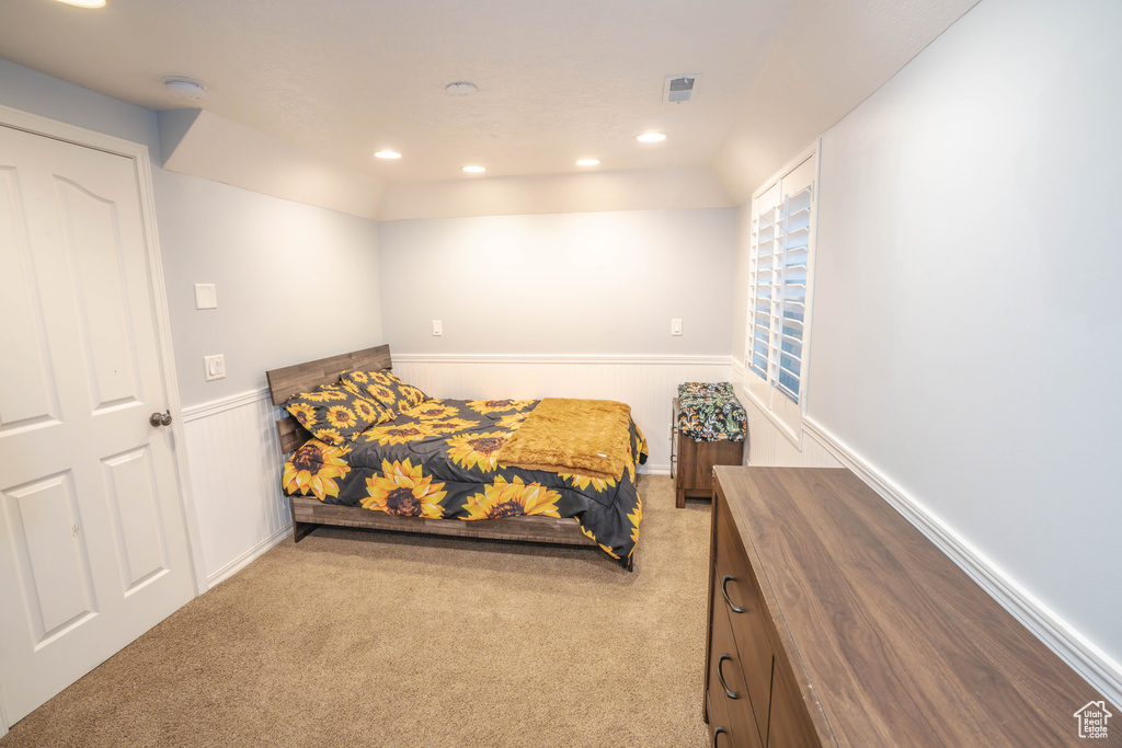 Bedroom featuring recessed lighting, wainscoting, and carpet