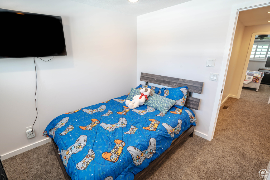 Carpeted bedroom featuring baseboards