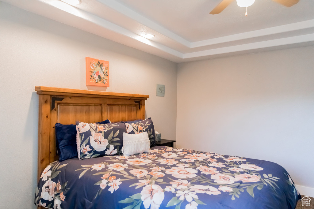 Carpeted bedroom featuring a ceiling fan and recessed lighting