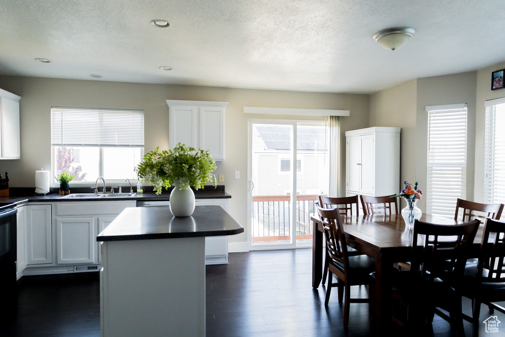 Dining area with recessed lighting, a textured ceiling, and dark wood finished floors
