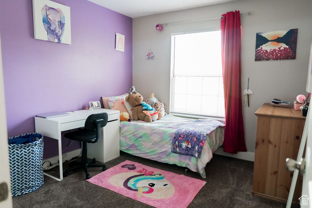 Carpeted bedroom featuring multiple windows