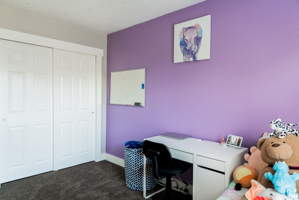 Office space with baseboards and dark colored carpet