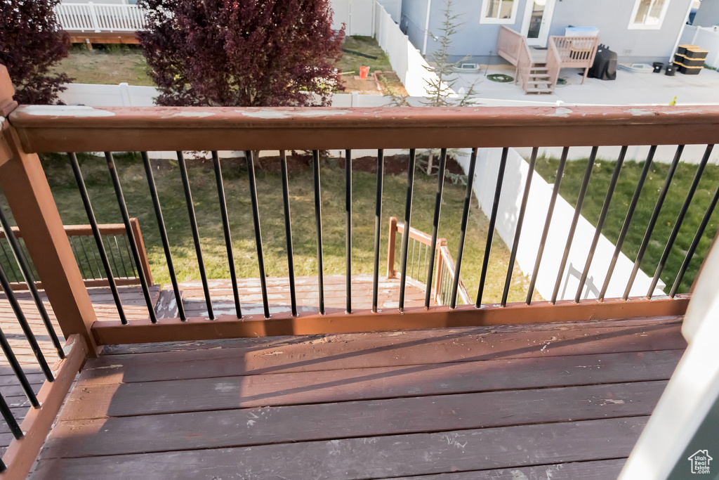 Wooden terrace featuring fence