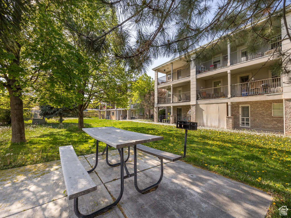 View of property's community with a patio and a yard