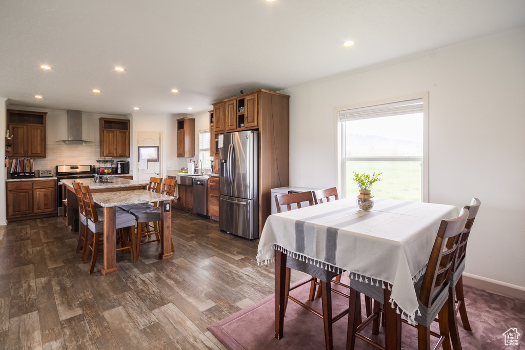Dining area featuring recessed lighting, dark wood-style floors, and baseboards