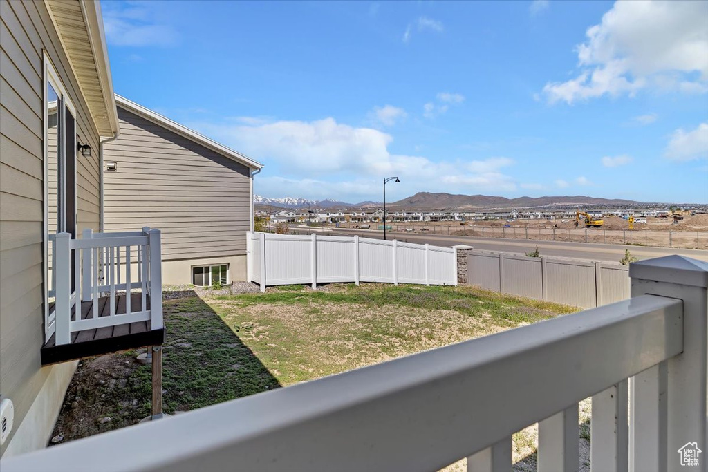 View of yard with a mountain view and fence