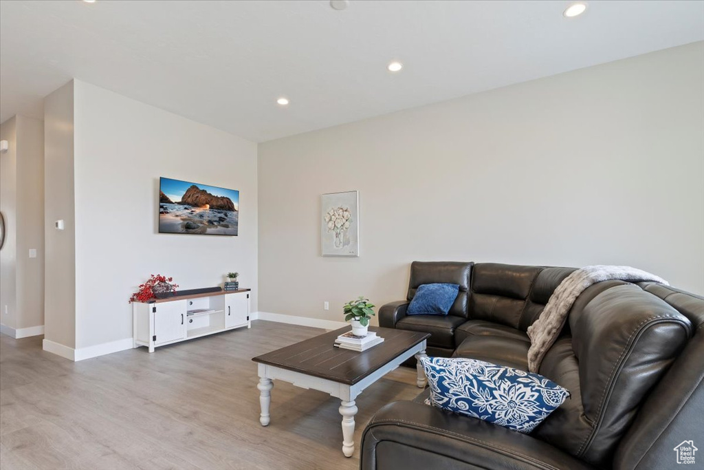 Living area featuring baseboards, wood finished floors, and recessed lighting