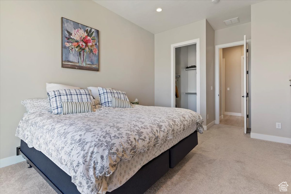 Bedroom featuring light colored carpet, recessed lighting, baseboards, and visible vents