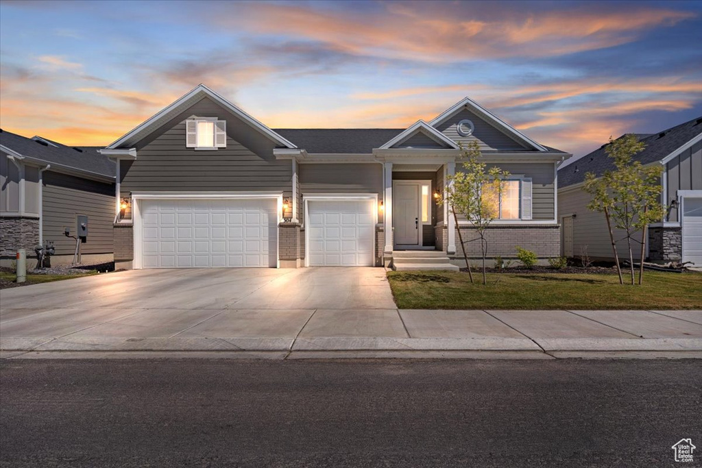 View of front facade with driveway and a front yard