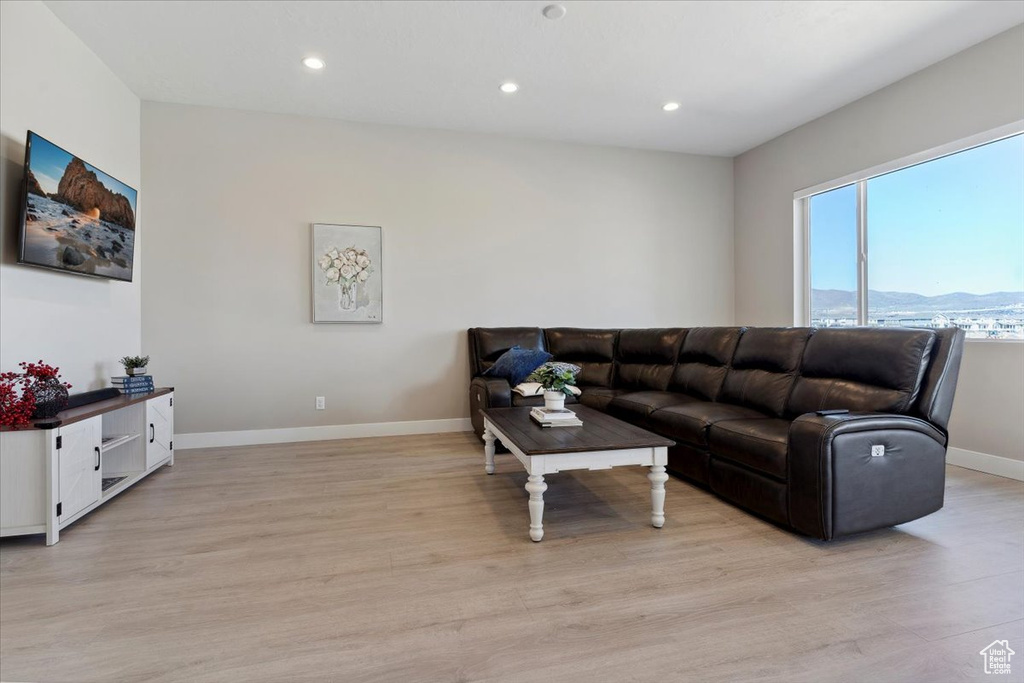 Living room with baseboards, recessed lighting, light wood-style flooring, and a mountain view