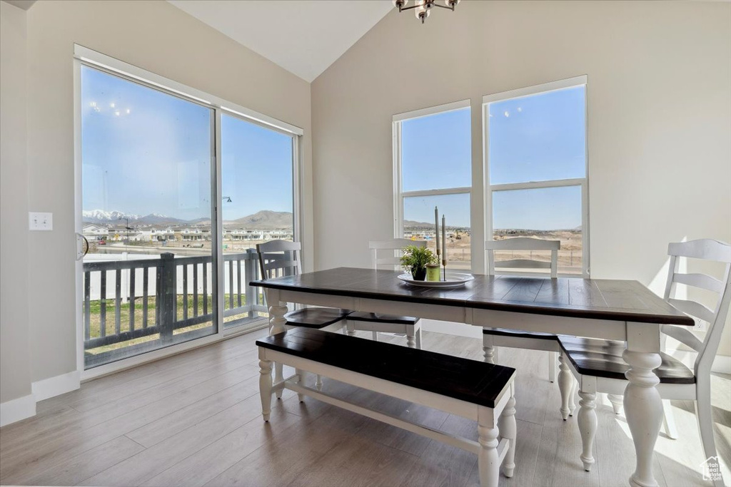 Dining area featuring wood finished floors, lofted ceiling, and a healthy amount of sunlight