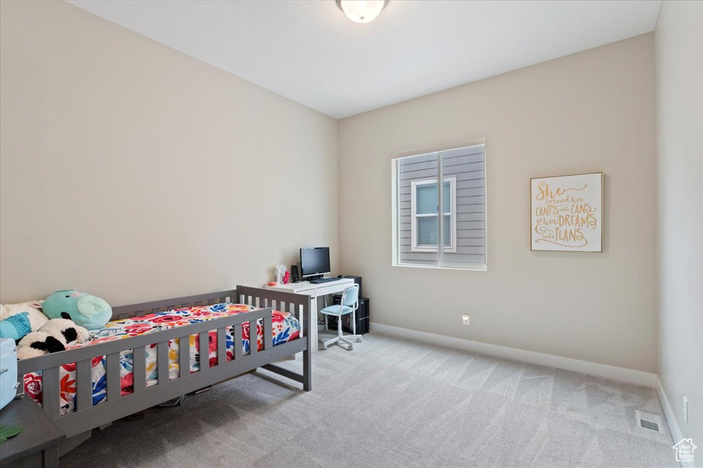 Bedroom featuring carpet floors and baseboards