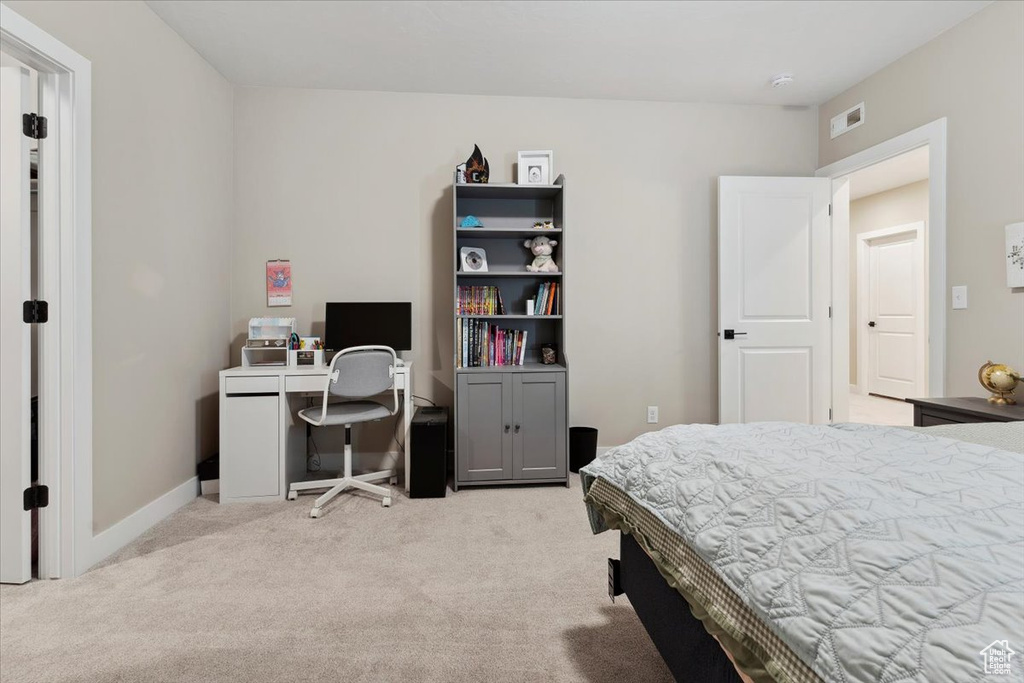 Bedroom with baseboards, visible vents, and carpet