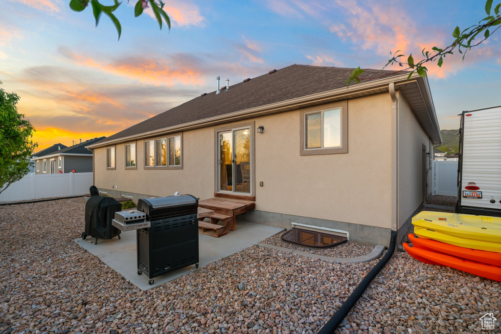 Back of house with a patio, roof with shingles, fence, and stucco siding