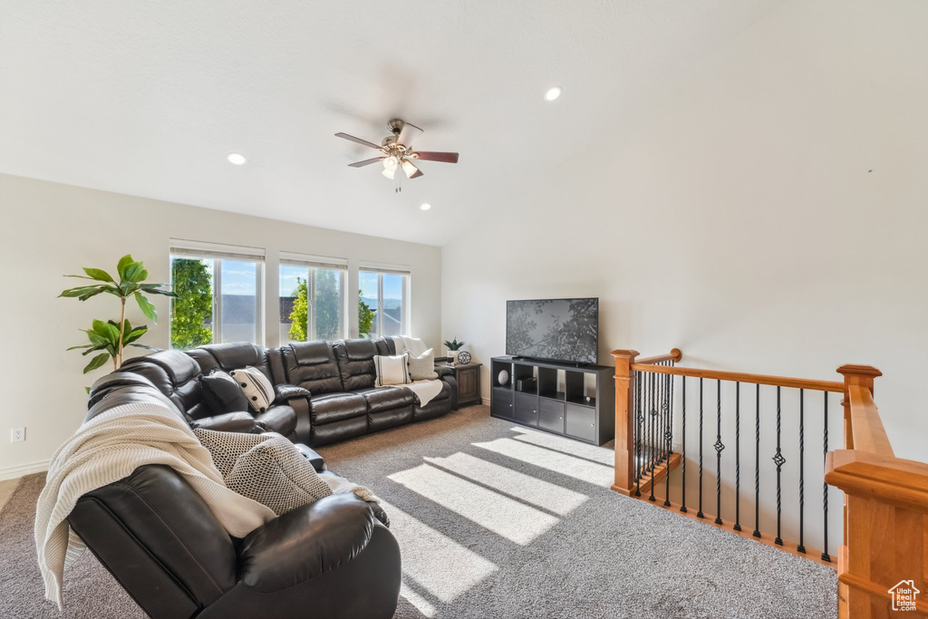 Carpeted living area featuring vaulted ceiling, a ceiling fan, and recessed lighting