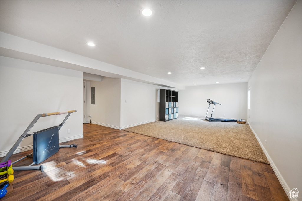 Below grade area with recessed lighting, baseboards, and hardwood / wood-style flooring