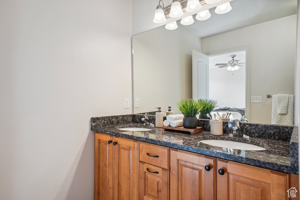 Full bath with double vanity, a sink, and ensuite bath