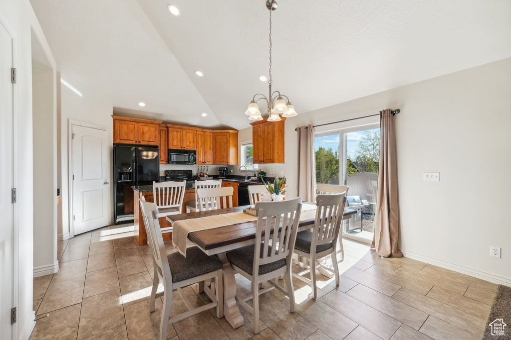Dining space with recessed lighting, high vaulted ceiling, a notable chandelier, and baseboards