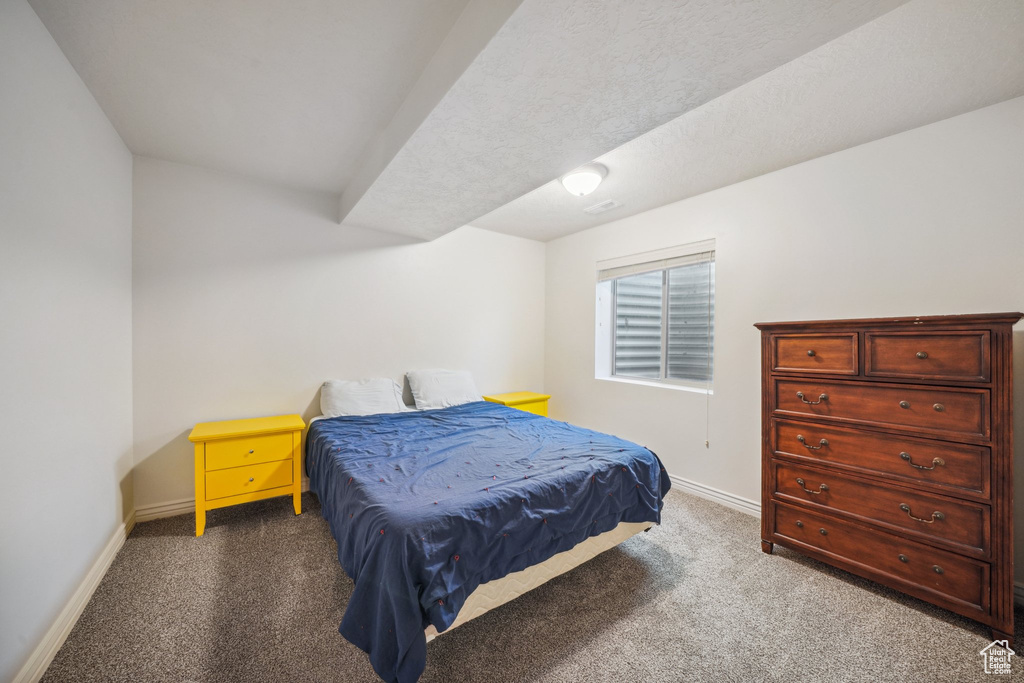 Carpeted bedroom with baseboards