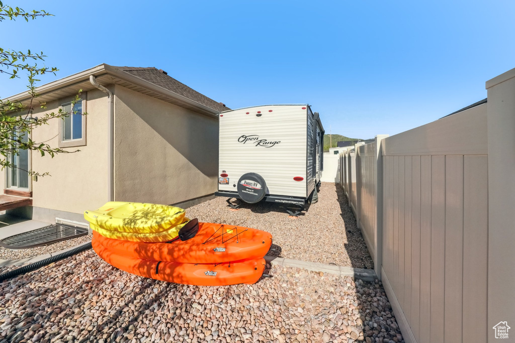 View of property exterior with fence and stucco siding