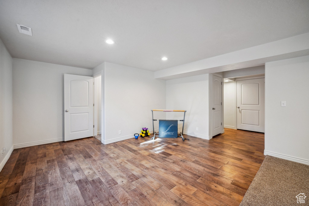 Unfurnished living room with baseboards, recessed lighting, wood finished floors, and visible vents