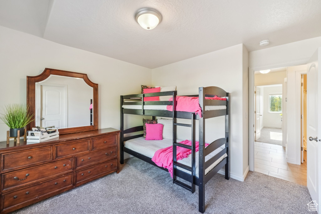 Bedroom with light colored carpet