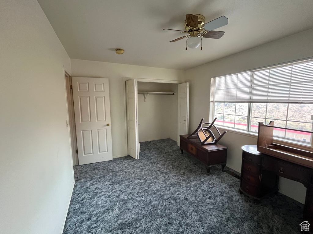 Bedroom featuring carpet flooring, a ceiling fan, baseboards, and a closet