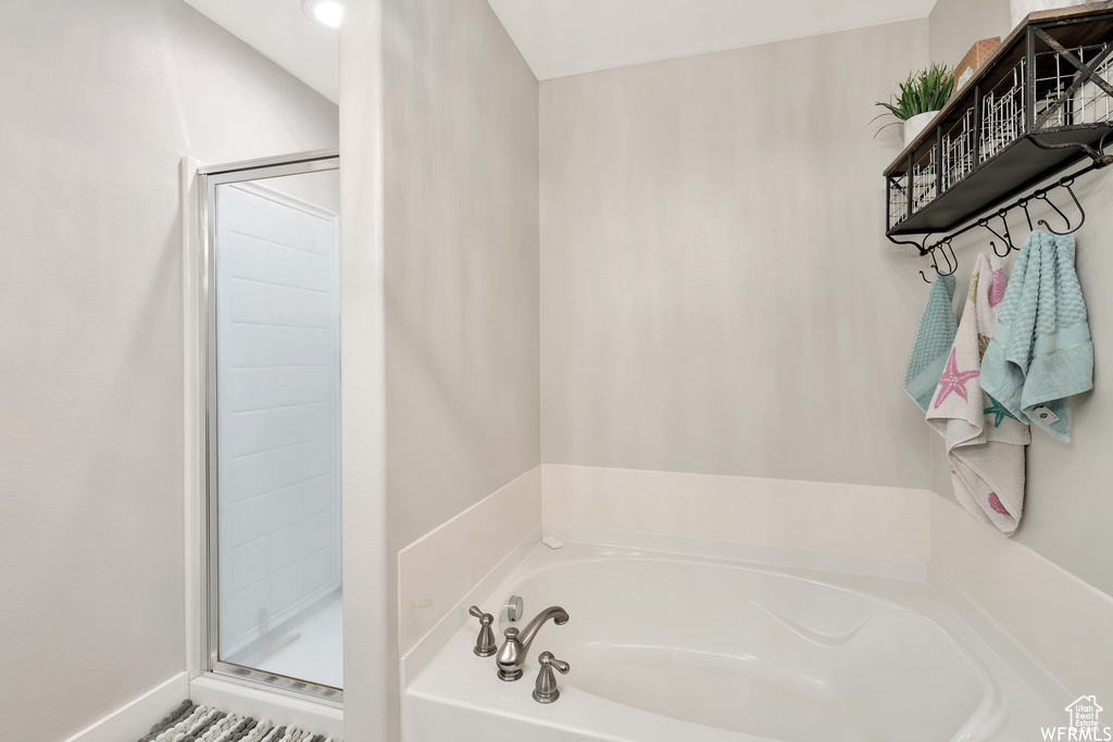 Bathroom with a bath and a stall shower