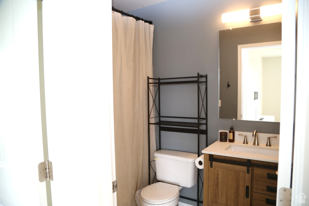 Full bath with toilet and vanity