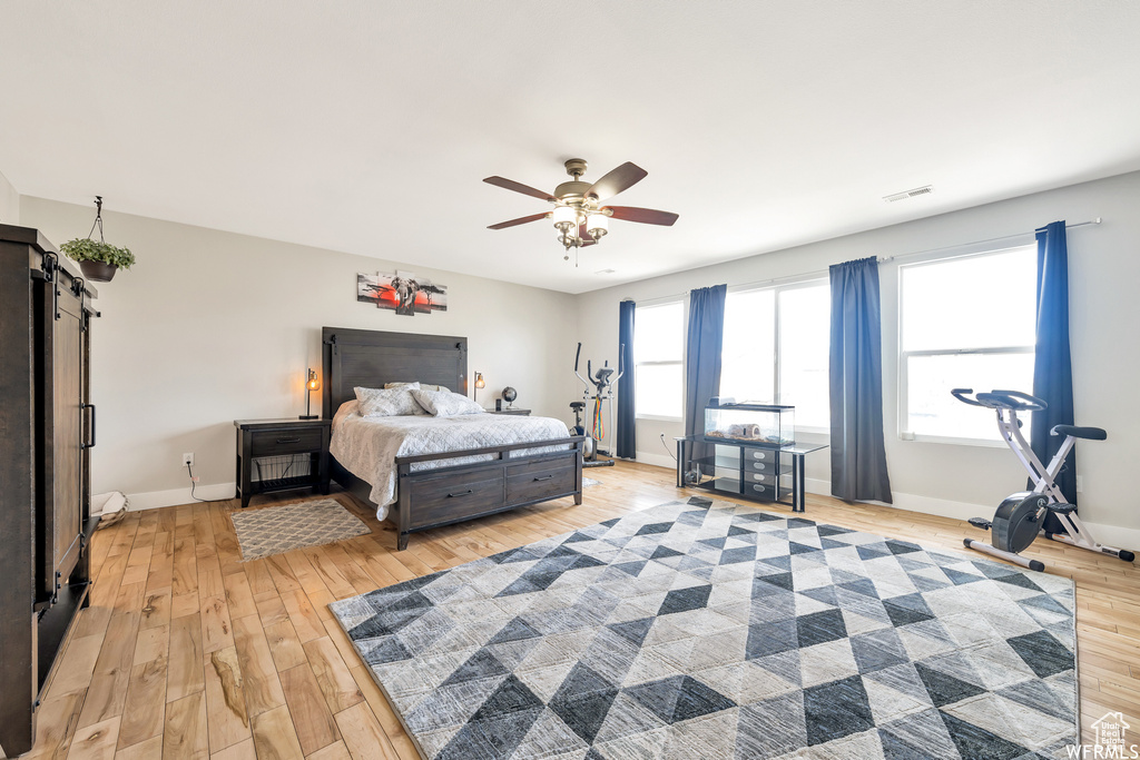Bedroom with light wood-style floors, baseboards, and visible vents