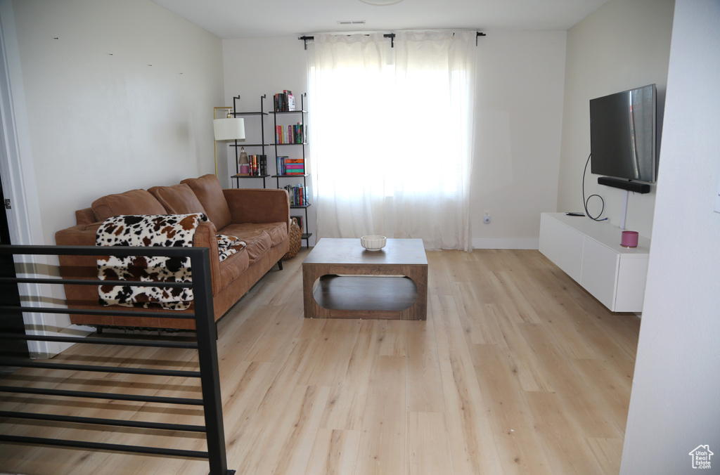 Living room featuring light wood-style floors and baseboards