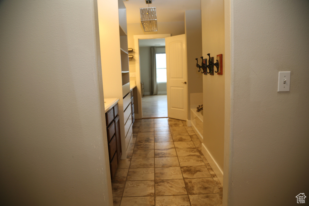 Hall featuring baseboards and a textured wall