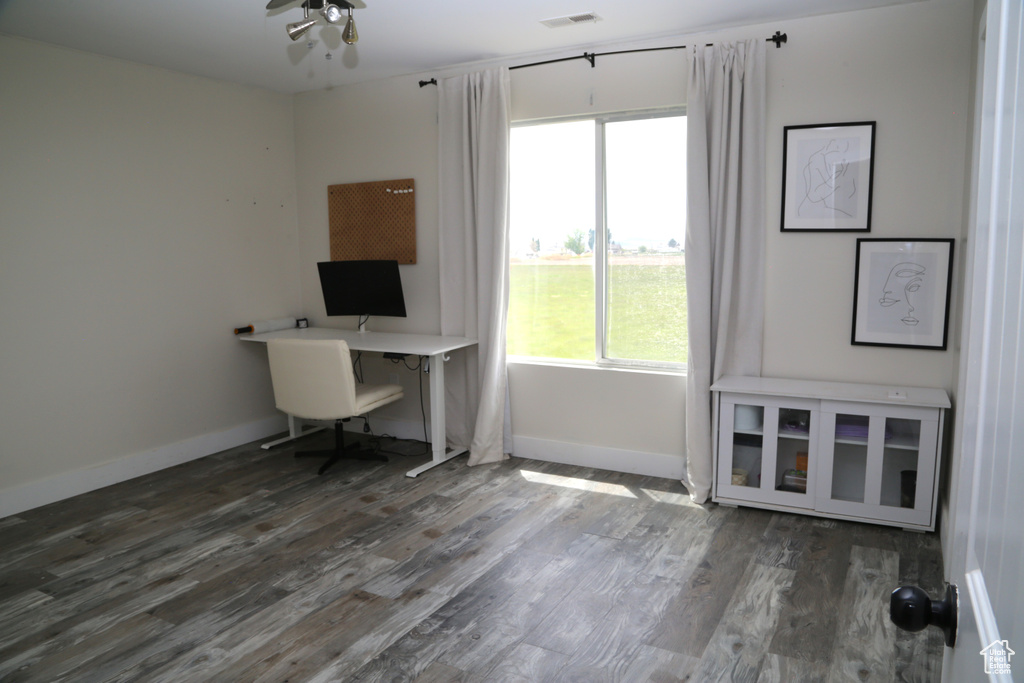 Home office with wood finished floors, baseboards, and ceiling fan