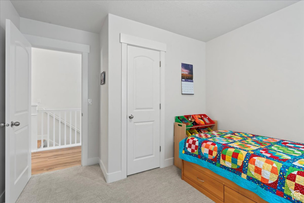 Carpeted bedroom with baseboards
